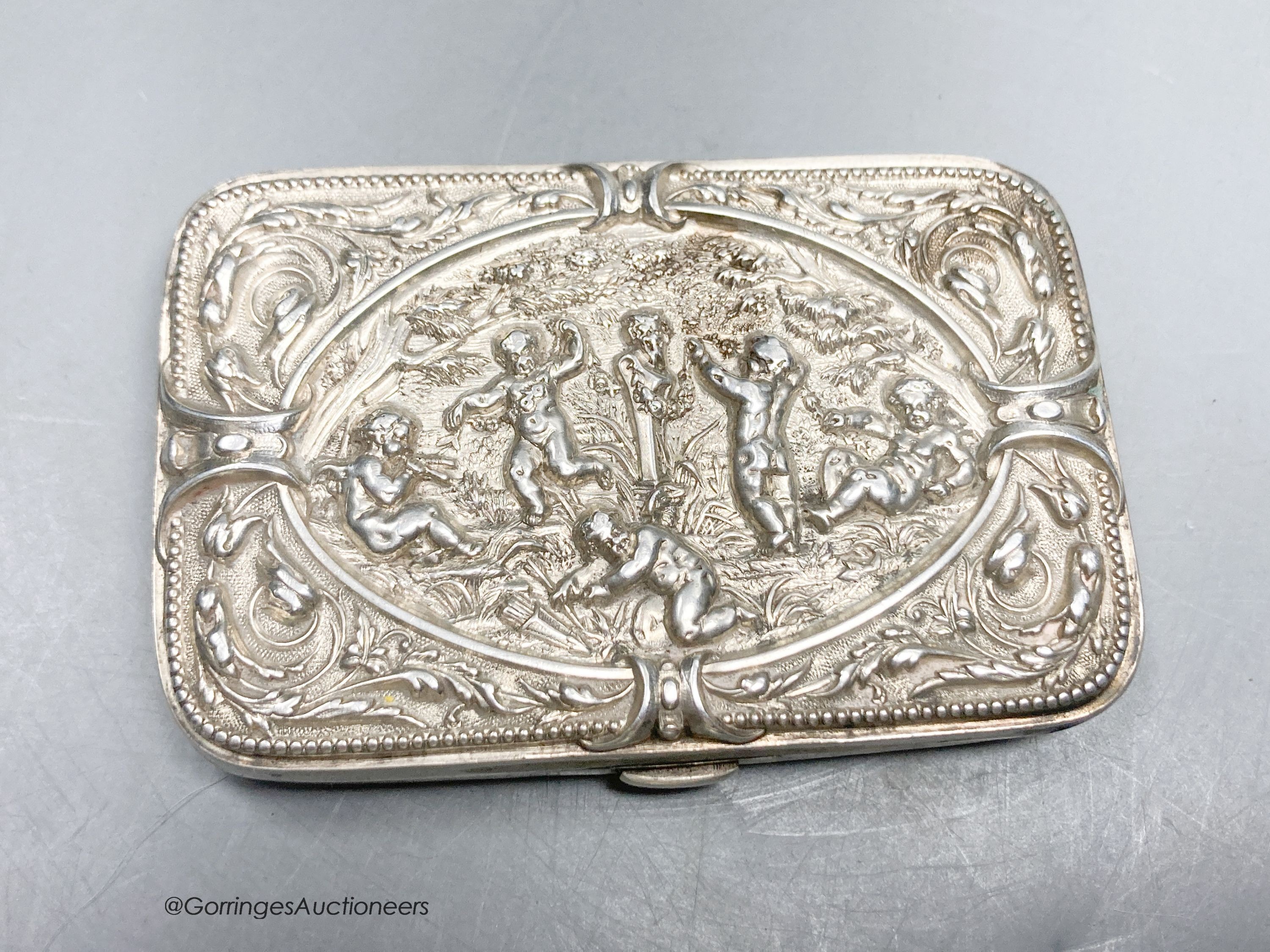 A late Victorian embossed silver shaped rectangular cigarette case, with mirrored interior, Birmingham, 1889, 81mm.